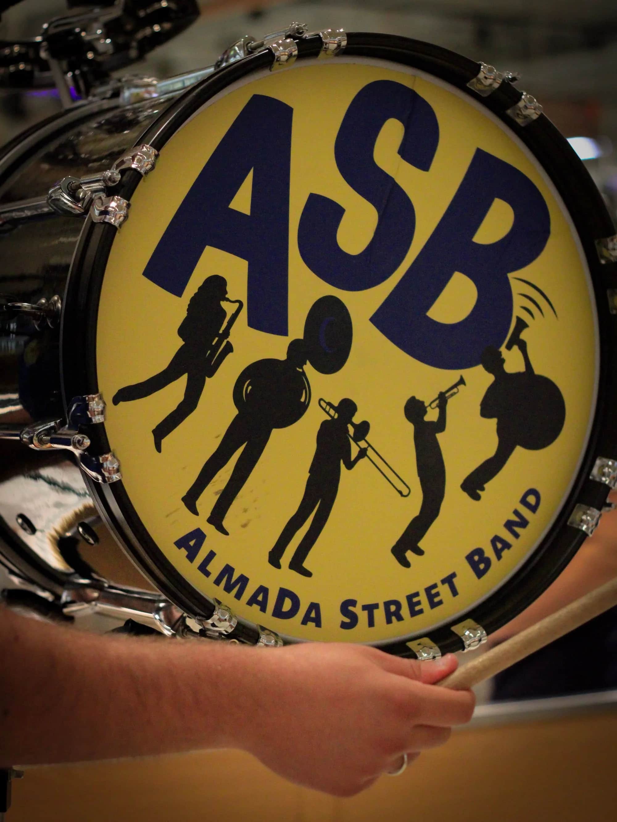 The ASB logo on a bass drum head at night